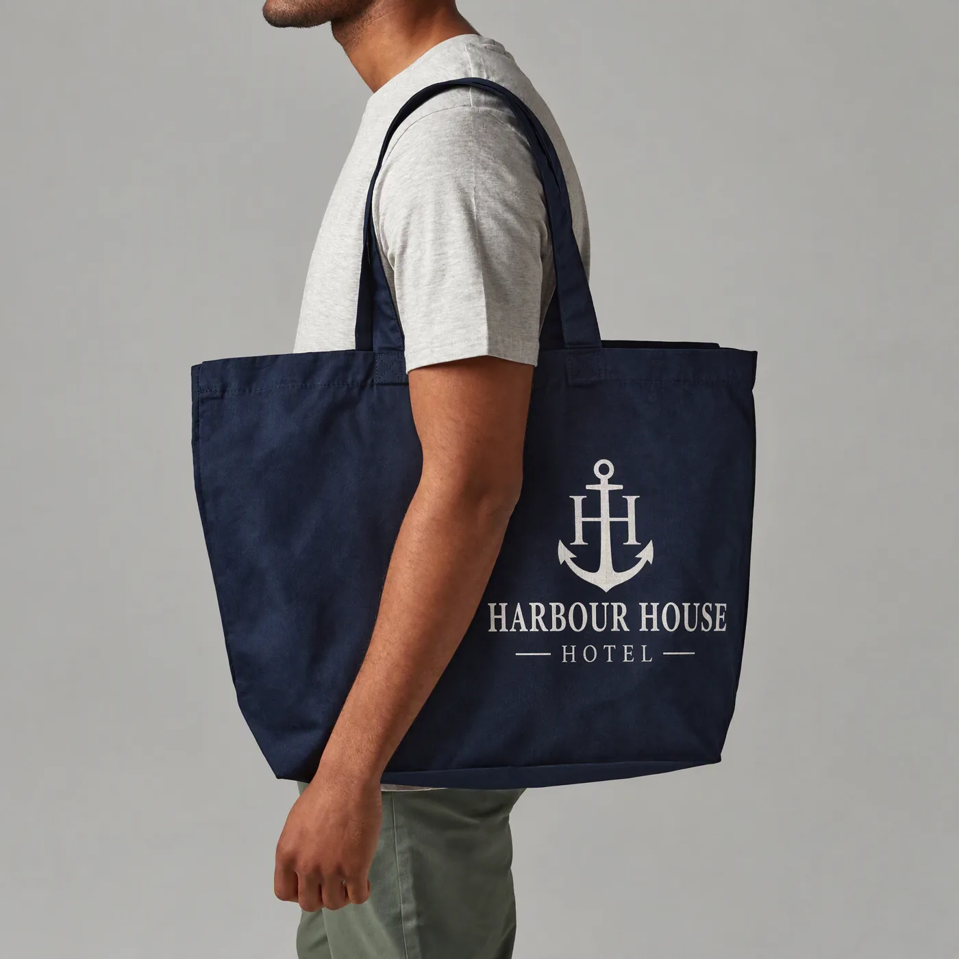Navy cotton tote printed with a Harbour House Hotel anchor logo, carried over the shoulder